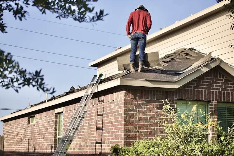 Professional roofer working on a residential roof in La Belle Fontane Estates